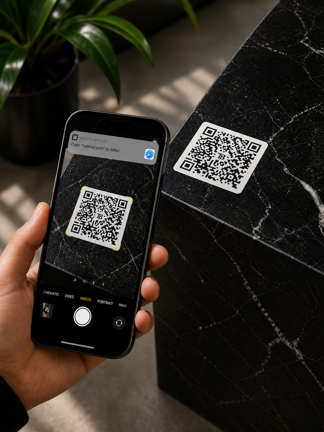 Phone scanning a TatBrief QR at a studio